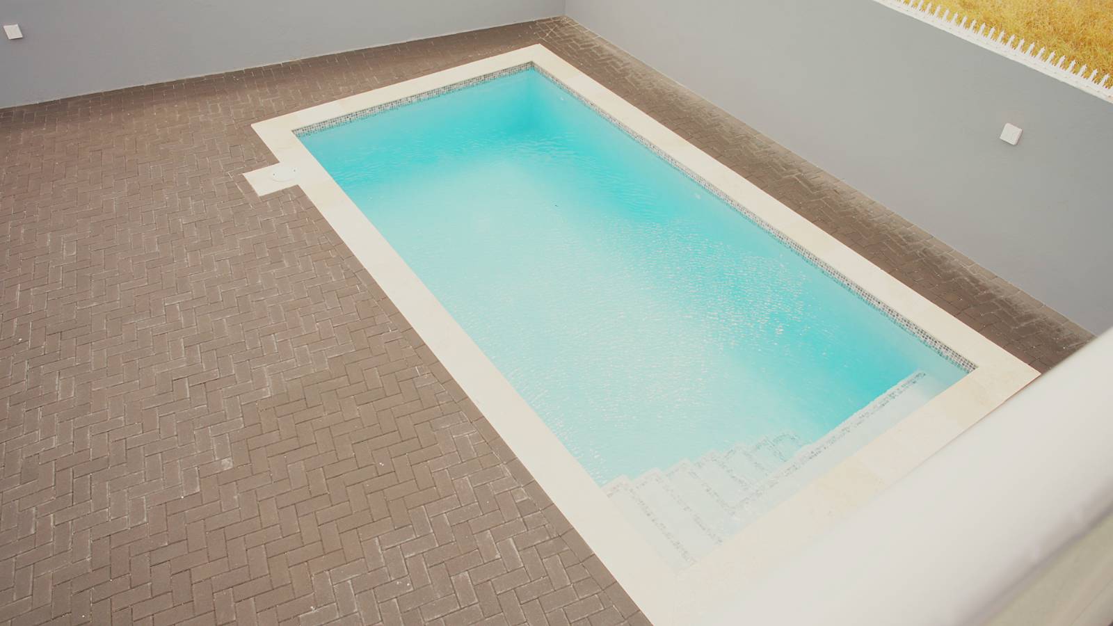 The turquoise swimming pool at D’ZSHA Residences